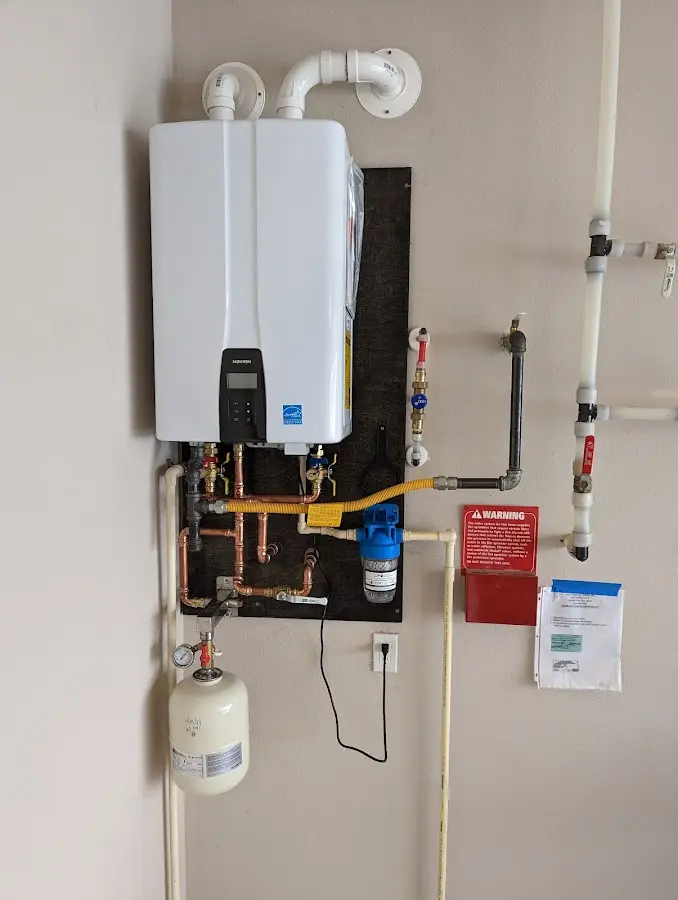 Professional plumber installing copper piping in a Glassmanor home